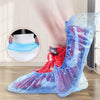 A person's foot is wearing clear plastic shoe covers with water droplets on a wooden floor.