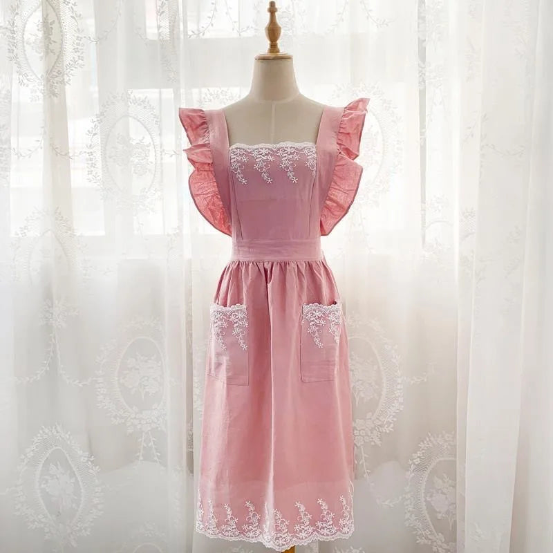 Pink lace detail cotton linen kitchen apron displayed on a mannequin.