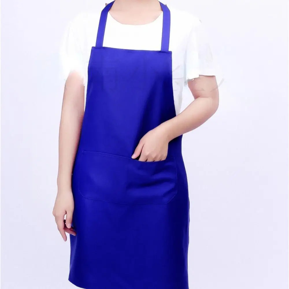 A person wearing a royal blue oil-proof cooking apron over a white shirt.