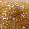 A close-up of a DIY miniature landscape kit featuring simulated grass and small stones on a textured surface.