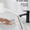 A hand is using a multi-function glass cleaner and scraper to clean a sink, showing water flowing from the device.