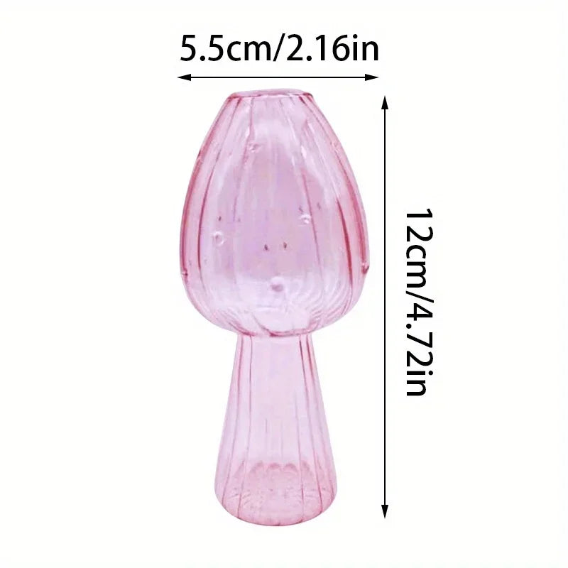 A pink glass mushroom vase with a flared top and tapered base.