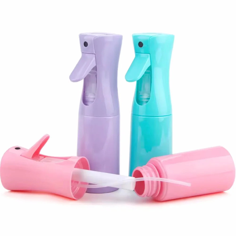 Three colorful refillable mist spray bottles in purple, teal, and pink are shown side by side.