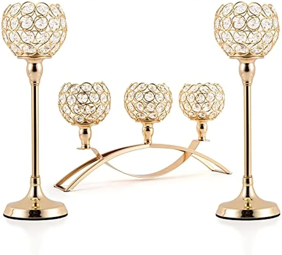 A set of gold crystal tealight candlesticks with decorative glass heads and a curved stand.