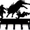 Black silhouette of a horse and rider on a decorative metal key holder rack with hooks