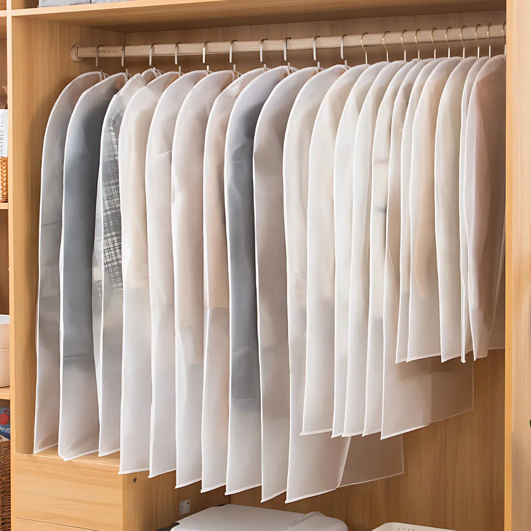 A display of white and sheer fabric dust covers for washable clothes hanging on wooden hangers.