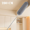 A long, extendable microfiber duster with a fluffy gray head is shown against a light-colored cabinet and ceiling.