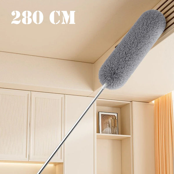 A long, extendable microfiber duster with a fluffy gray head is shown against a light-colored cabinet and ceiling.