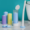 A set of disappearing toilet brushes in purple and yellow with a long white handle displayed on a marble surface.