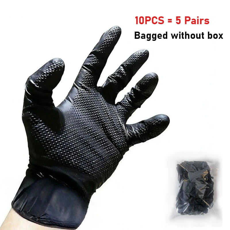 A hand wearing a black, extra thick heavy-duty disposable nitrile glove with a diamond texture is shown next to a packaged pa