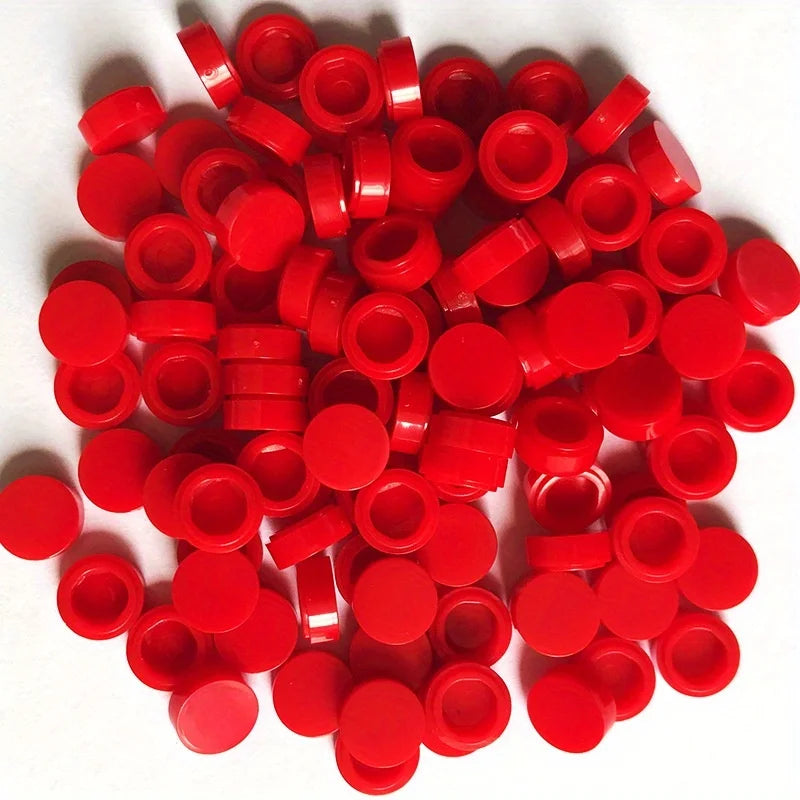 A pile of small, round red building blocks for DIY projects.