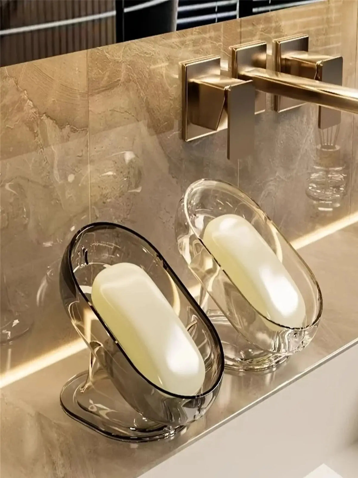 Elegant lightweight glass soap dish with a white bar of soap on a marble countertop.