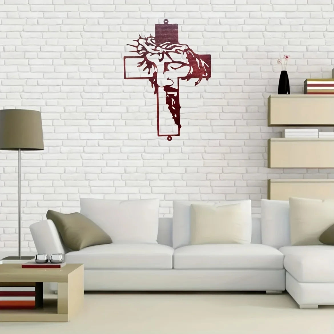 Elegant metal cross wall art decor featuring a dark red silhouette on a white brick wall above a modern sofa.