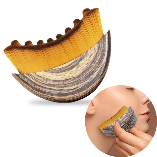 A wooden ergonomic lymphatic contour face brush with golden bristles shown next to a hand applying it to a woman's face.