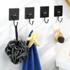 Black heavy-duty self-adhesive wall hooks with various hooks and a yellow starfish decoration