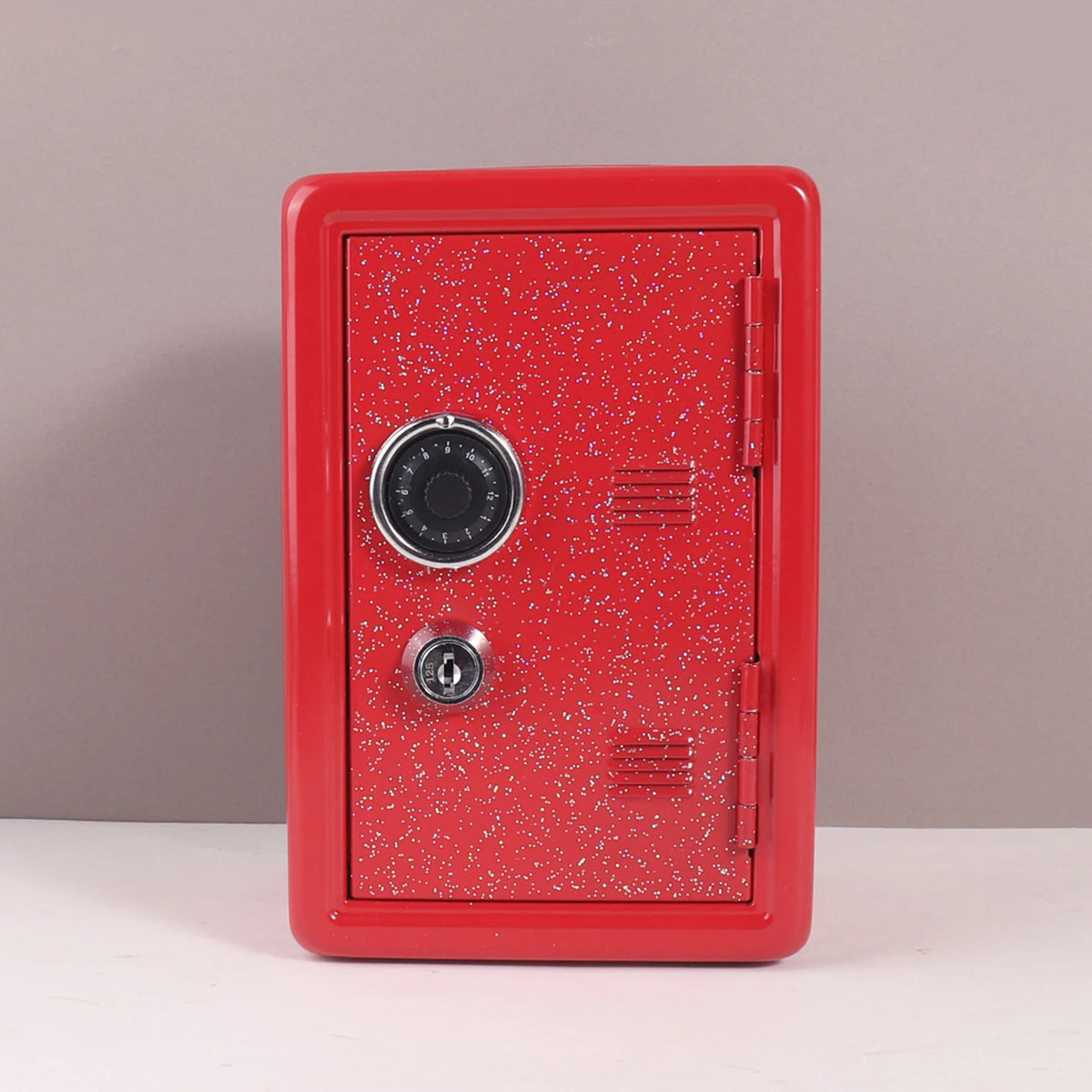 A red metal piggy bank with a combination lock and a textured surface is shown against a neutral background.