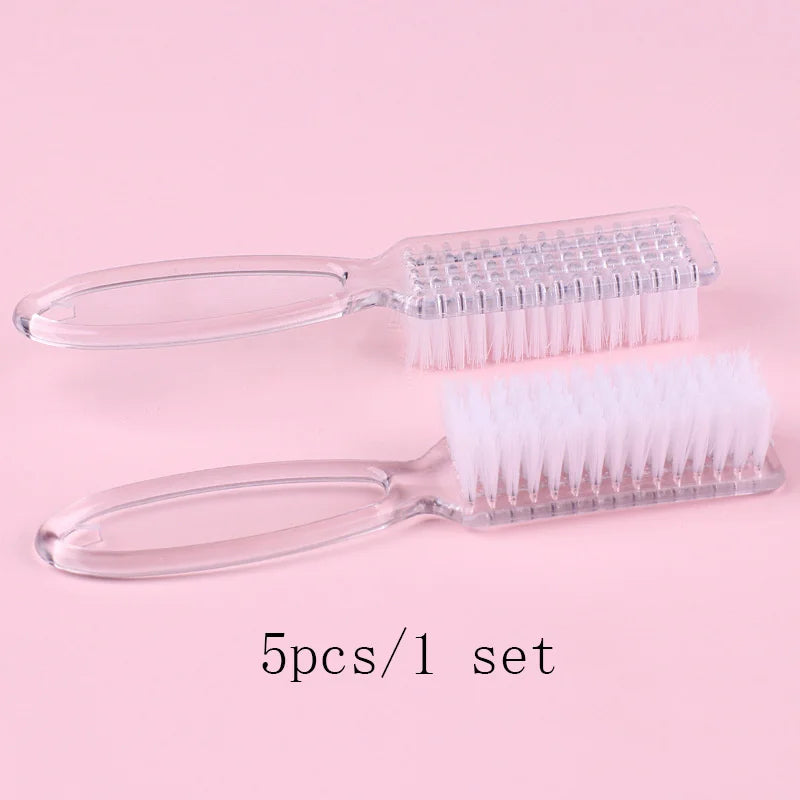 A set of five clear plastic brushes for nail art and dust cleaning displayed on a pink background.