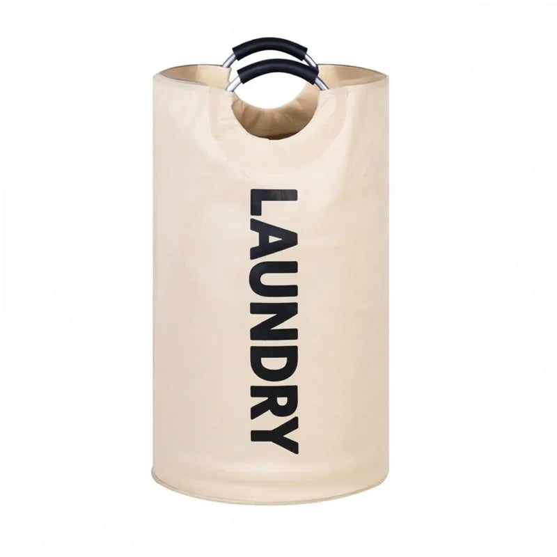 A beige foldable extra-large laundry basket with black padded handles.