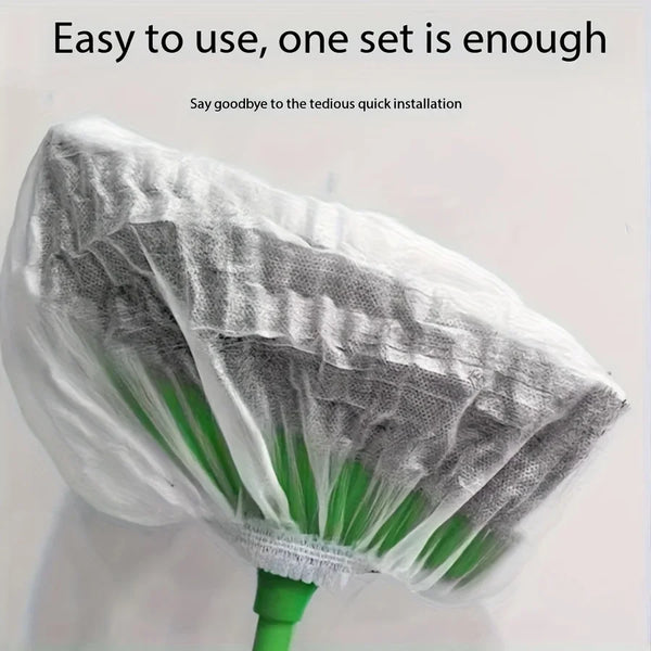 A white disposable broom and mop cover with green handles is shown against a white background.