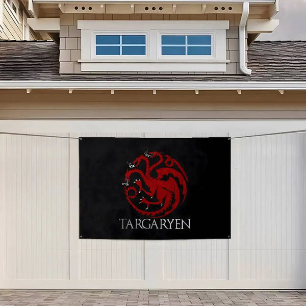 A black wall hanging tapestry featuring a red dragon logo and the name Targa Ryen on a white exterior wall.
