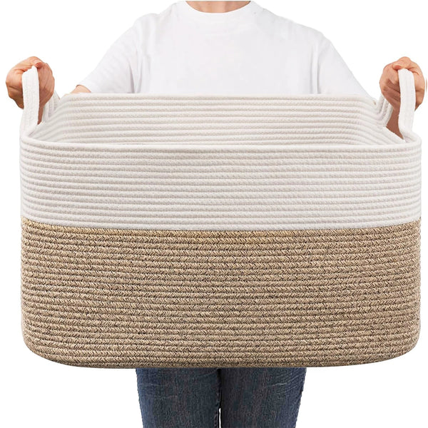 A person is holding a large woven cotton storage basket with light beige and brown striped sections.