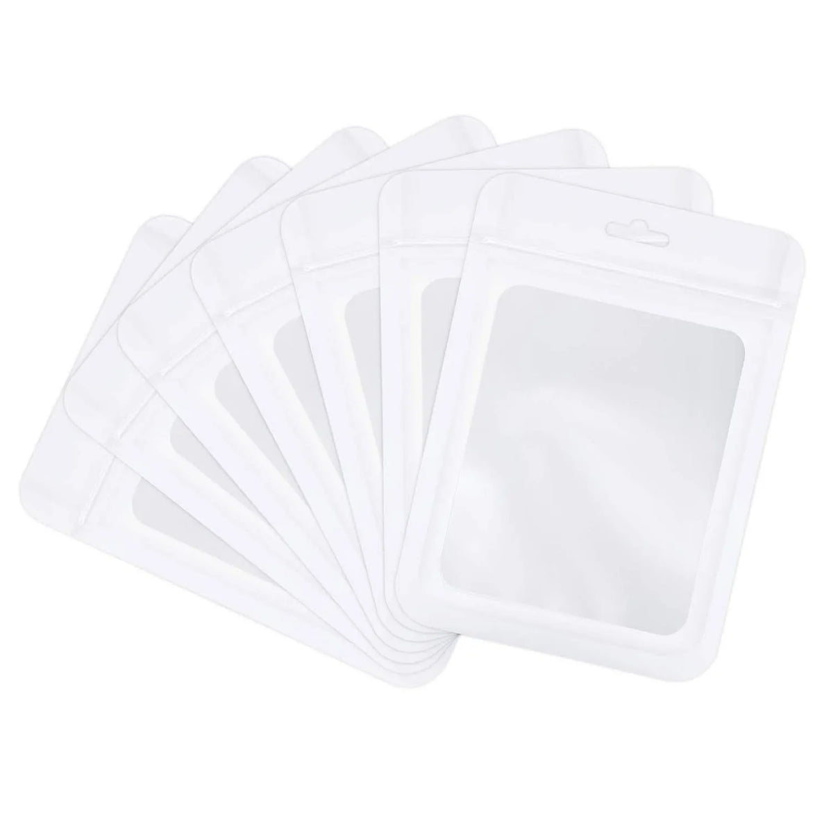 A stack of white jewelry display pouches or bags.