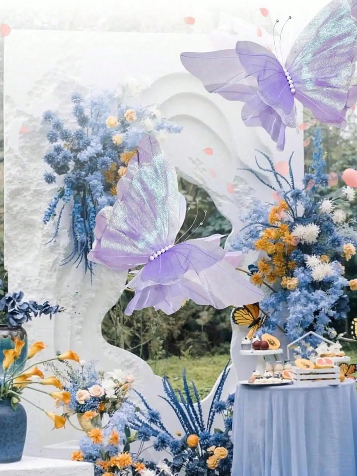 A floral and butterfly decoration featuring purple and blue flowers and butterflies on a white backdrop.