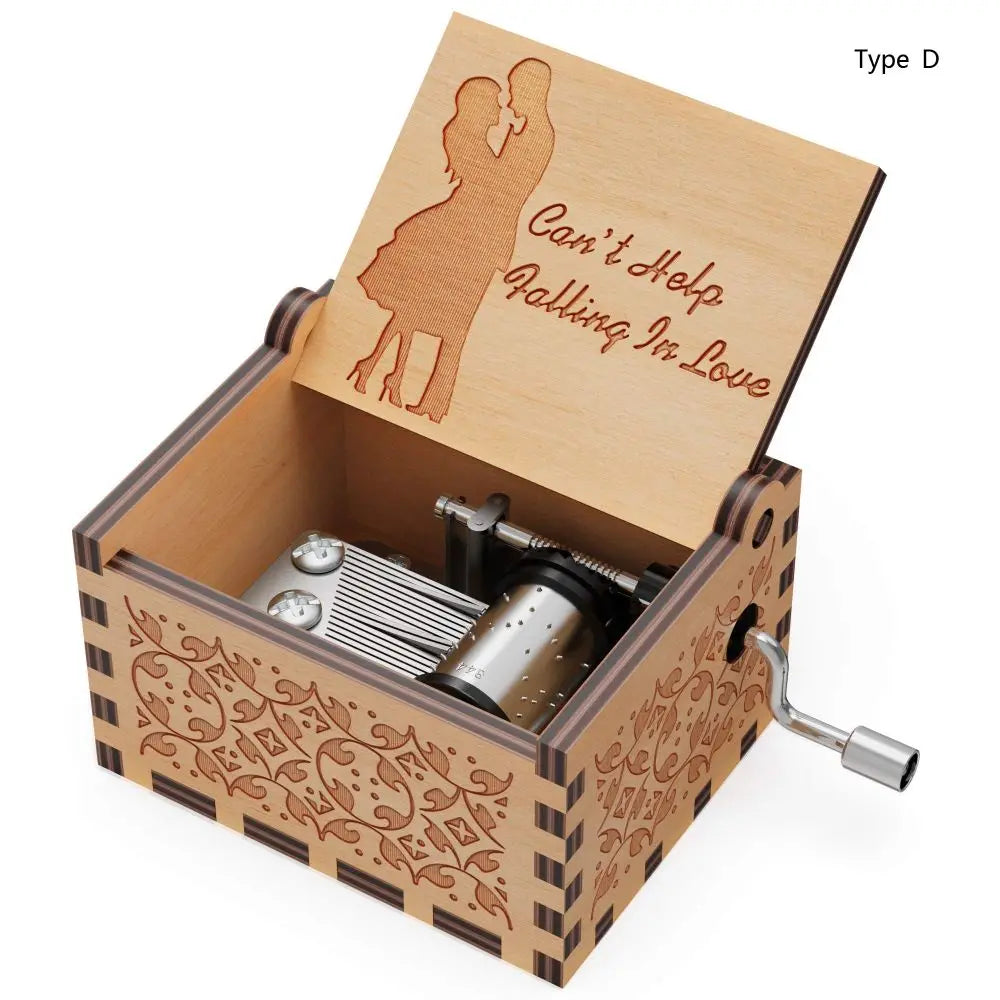 A wooden music box with an engraved lid featuring a silhouette of two people and decorative patterns.