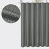A gray waterproof solid color shower curtain hanging from a rod.