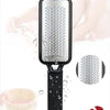 A black pedicure device foot scraper used for exfoliating skin and scraping calluses, shown next to a small bowl of product.