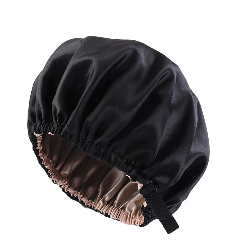 Black satin sleep cap with a gathered brim and a contrasting brown lining.