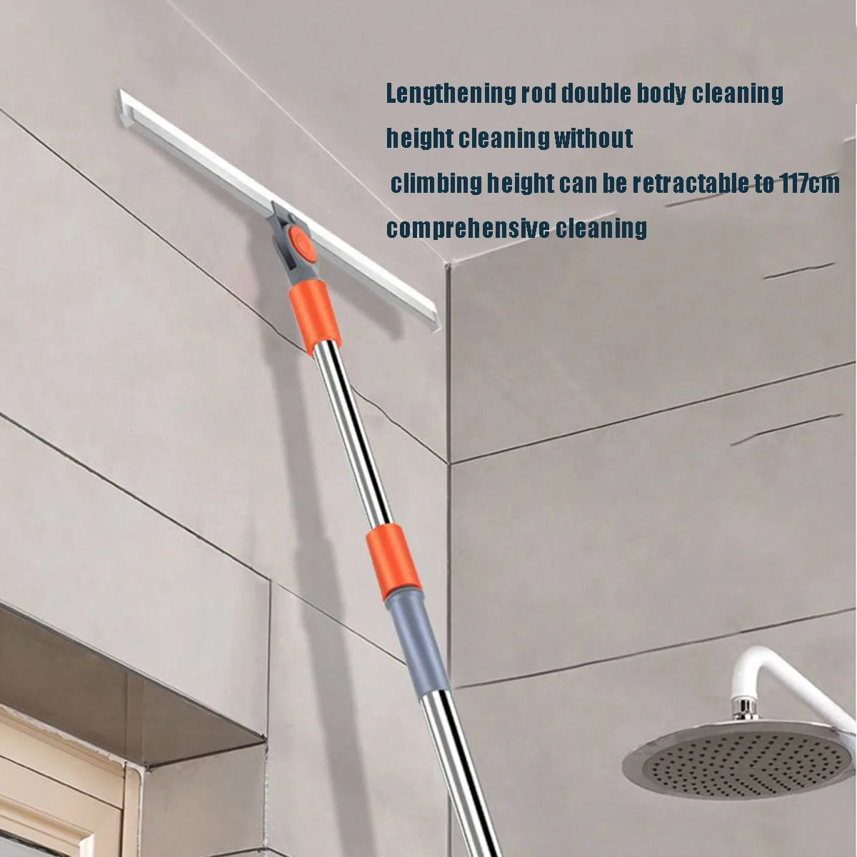 A silver and orange silicone squeegee broom with an aluminum handle is shown cleaning a ceiling.