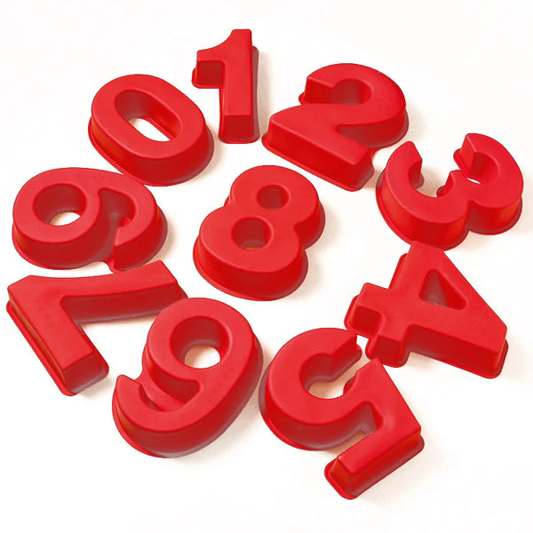 Red silicone number cake molds shaped like the digits 1 through 9 scattered on a white background.