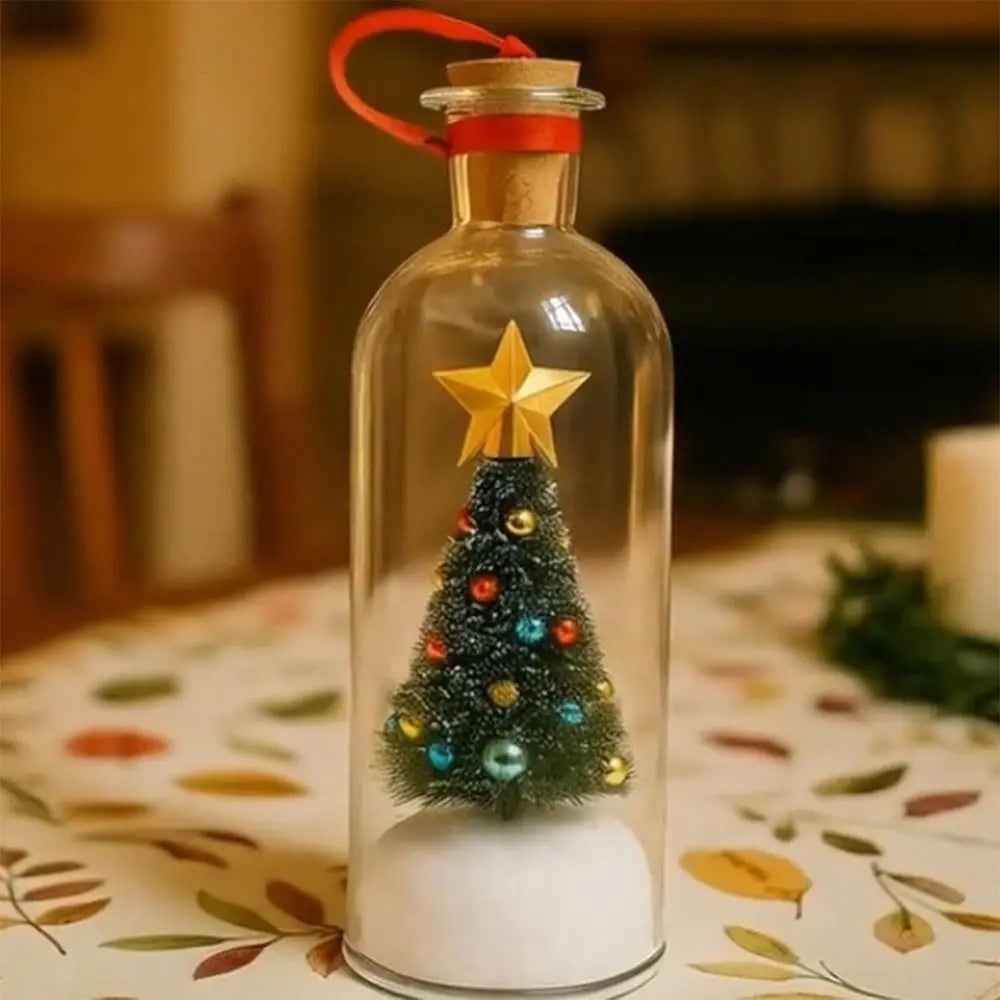 A clear glass bottle with a red cork and a gold star decoration, set on a patterned cloth.