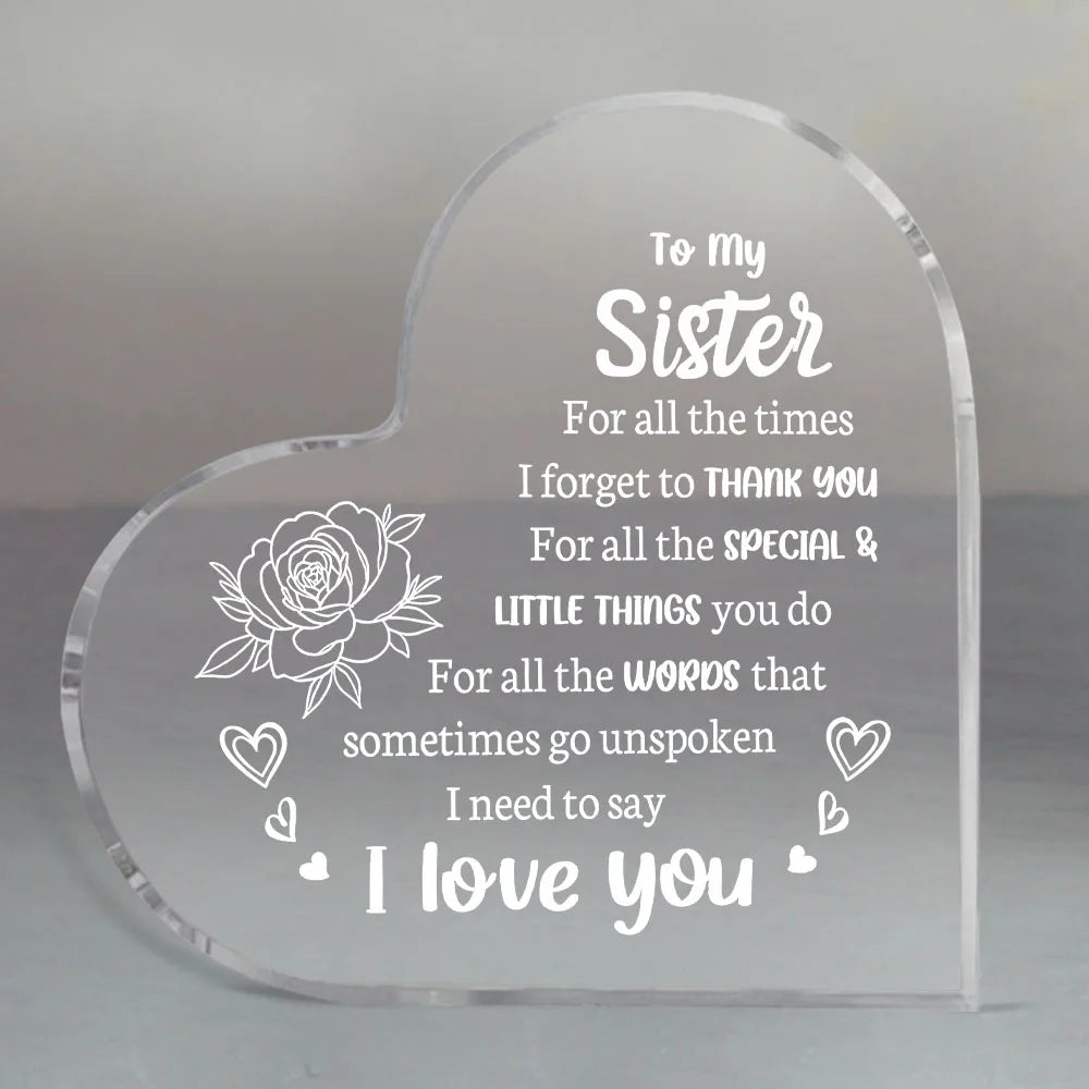 A clear acrylic heart-shaped keepsake engraved with the message I love you to my sister