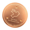 A round, copper purification disk featuring a silhouette of a bird and text indicating it is nature's purifier.