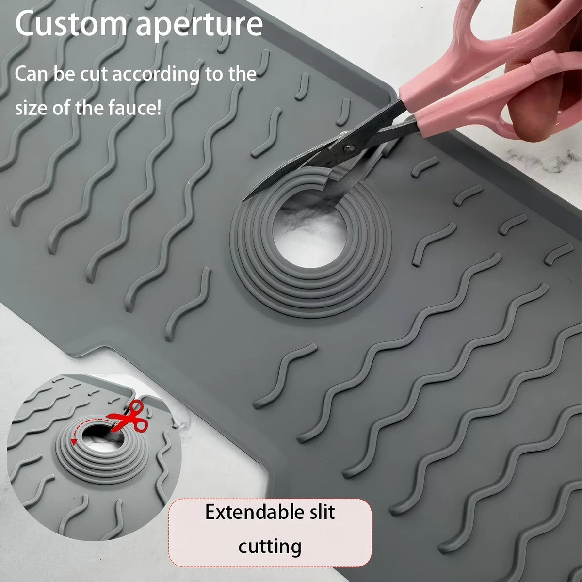 A silicone kitchen sink splash guard mat with a custom aperture feature being cut by scissors.