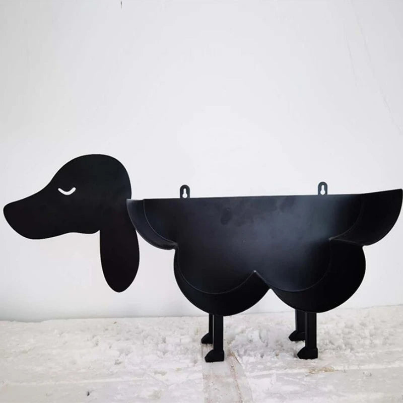 Black novelty animal toilet paper holder and storage rack with a dog-like head.