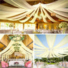 Elegant sheer chiffon draping fabric creating a flowing ceiling canopy for an event venue.