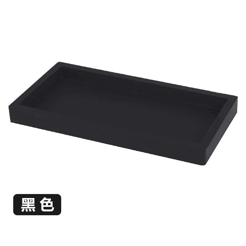 A rectangular black silicone tray organizer for kitchen or bathroom use.
