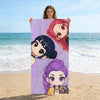 A woman holds up a vertical poster featuring glitter purple chibi anime characters against a beach background.