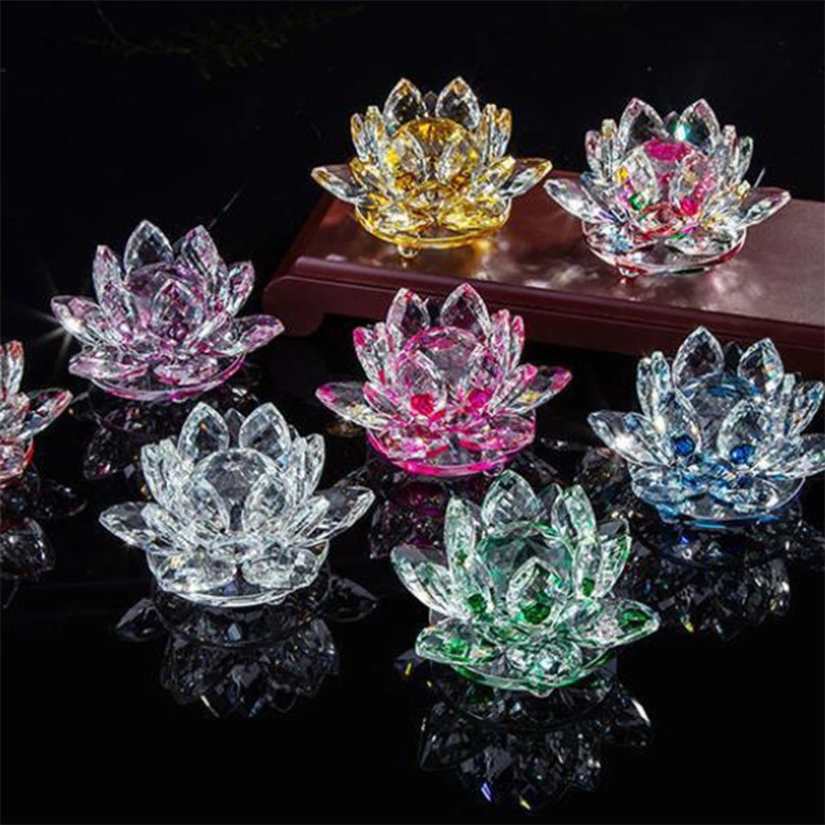 A collection of crystal lotus flower tabletop decor in various colors including yellow, pink, and blue