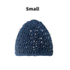A small, dark blue hand-crocheted mesh hair net cap.