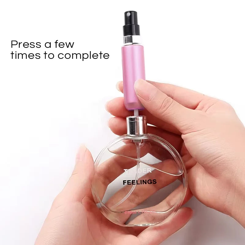 A hand is pressing a pink perfume bottle to complete the filling process for a portable refillable perfume spray.