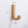 A natural oak wood wall hook shaped like a lowercase 'j' with mounting screws.