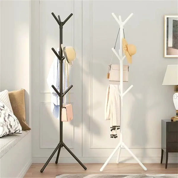 A tall, freestanding vertical coat and accessory rack with black and white branches displaying various clothing items.
