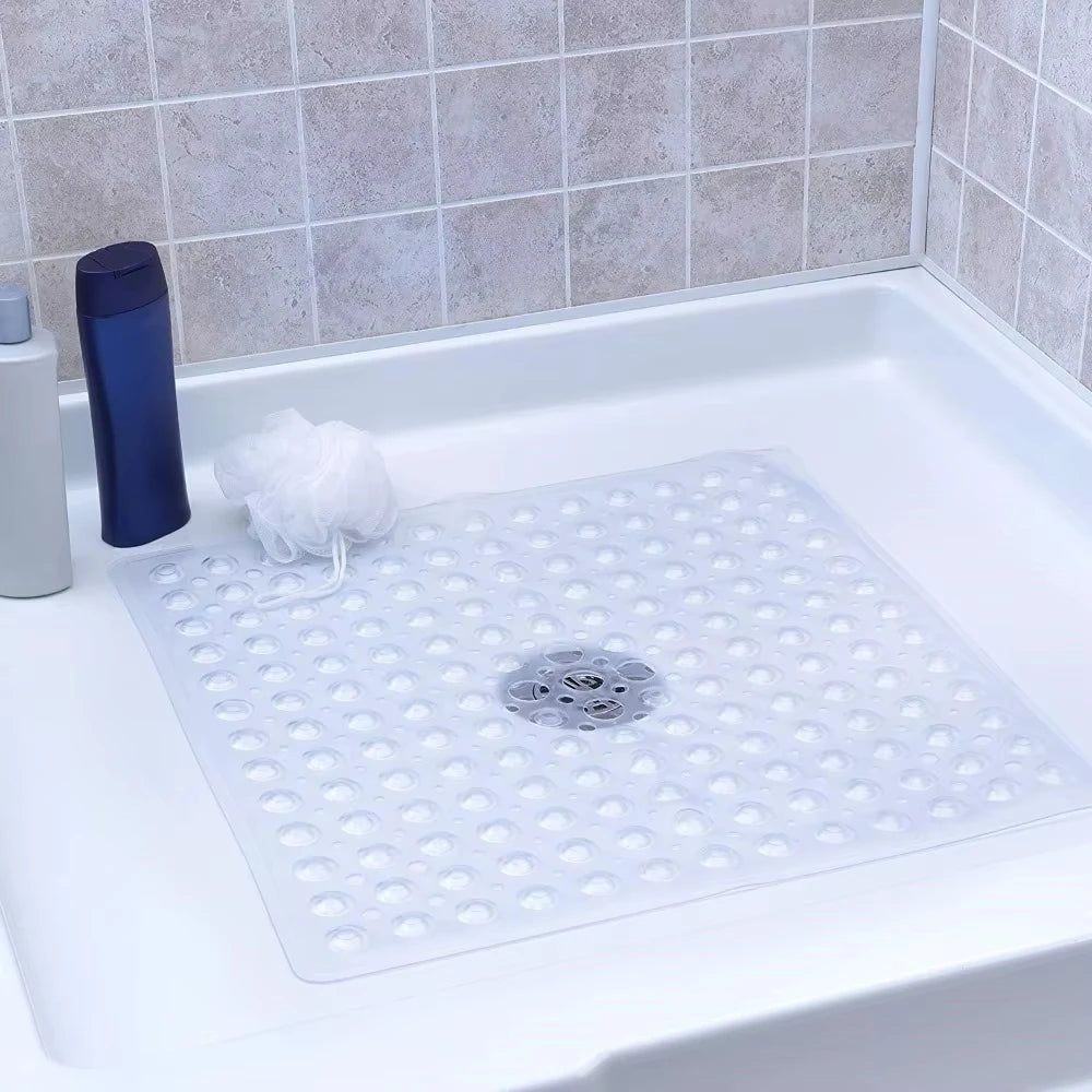 A white non-slip shower mat with suction cups is placed in a white bathtub.