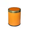 An orange durable press-type trash can with a gold rim and lid.