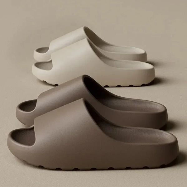 A pair of taupe EVA slides are shown in a light gray color, resting on a neutral background.