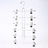 A silver adjustable pants hanger with swivel clips hanging from a hook.